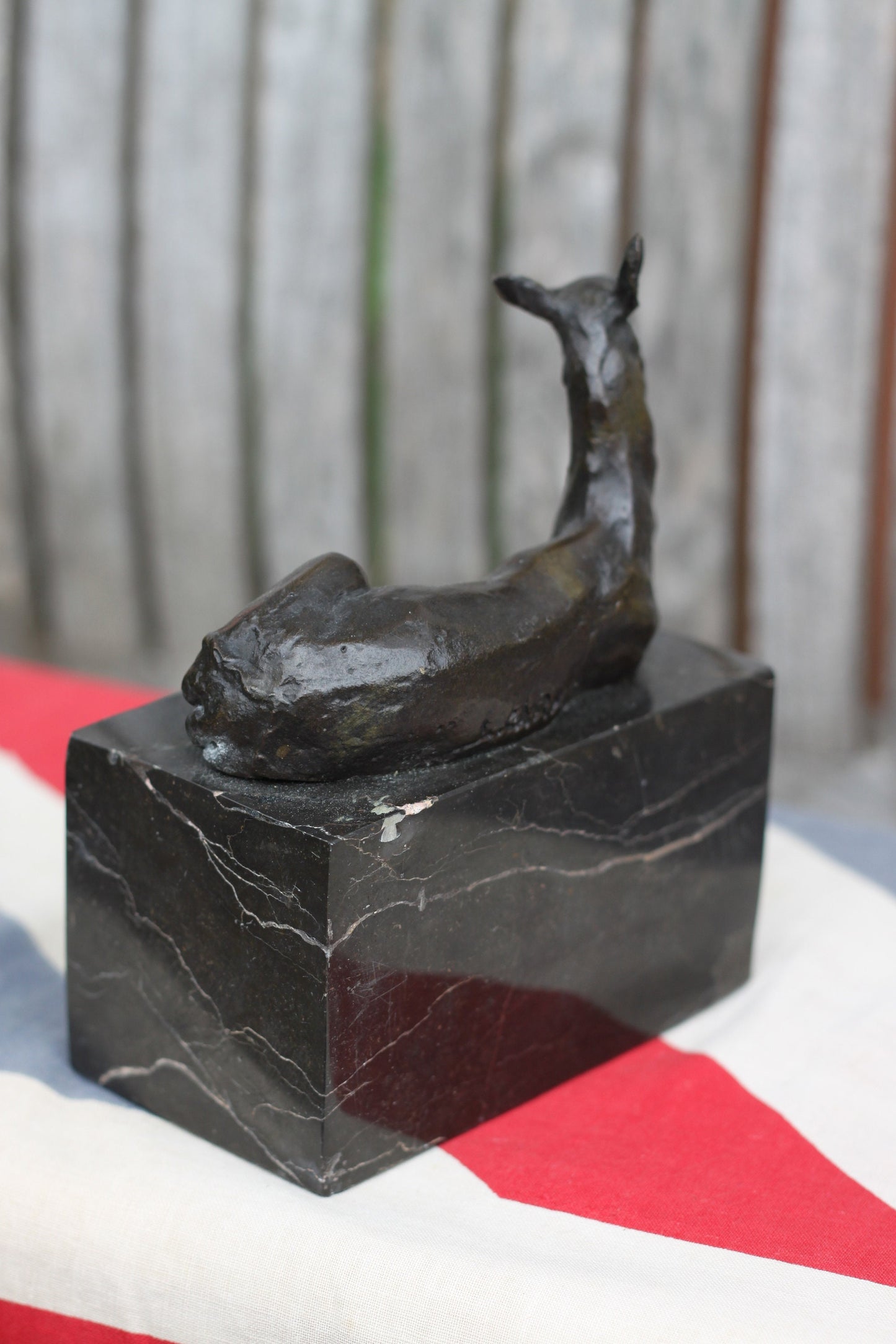 A  Patinated Bronze Study of a Recumbent Llama/Deer on a Black Marble Base Signed  L. Carvin, , 14cm in Length 1.98kg