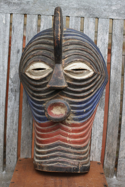 A Songye Kifwebe style African wooden wall mask - partially painted- hand carved , 37cm high