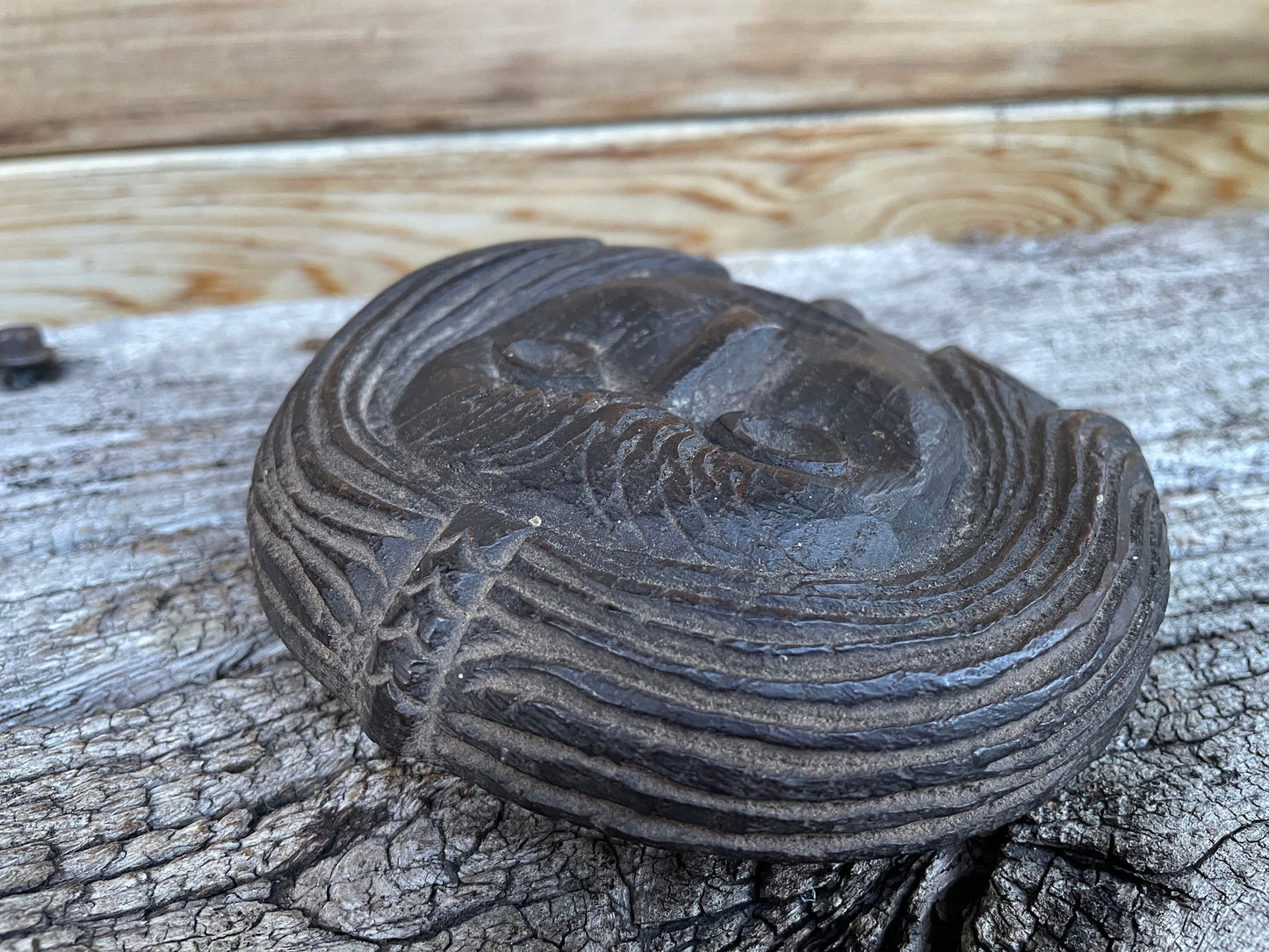 A 17th Century Carved Oak Folk Art Roundel Depicting a Long Haired Man, Diameter 12cm.