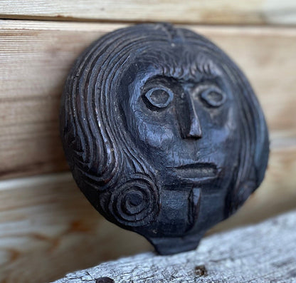 A 17th Century Carved Oak Folk Art Roundel Depicting a Long Haired Man, Diameter 12cm.