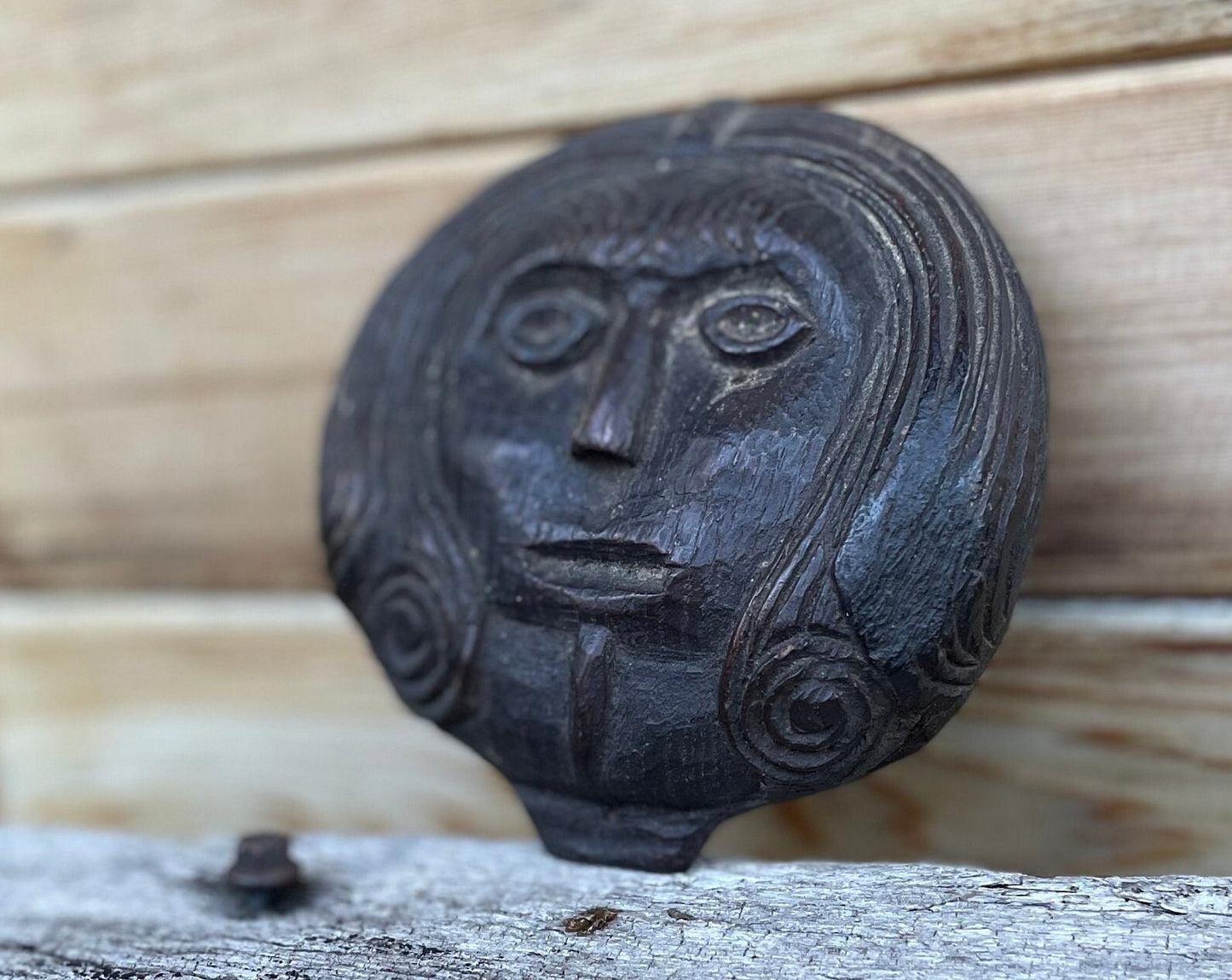 A 17th Century Carved Oak Folk Art Roundel Depicting a Long Haired Man, Diameter 12cm.