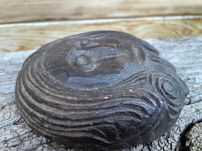 A 17th Century Carved Oak Folk Art Roundel Depicting a Long Haired Man, Diameter 12cm.