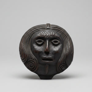 A 17th Century Carved Oak Folk Art Roundel Depicting a Long Haired Man, Diameter 12cm.