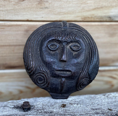 A 17th Century Carved Oak Folk Art Roundel Depicting a Long Haired Man, Diameter 12cm.