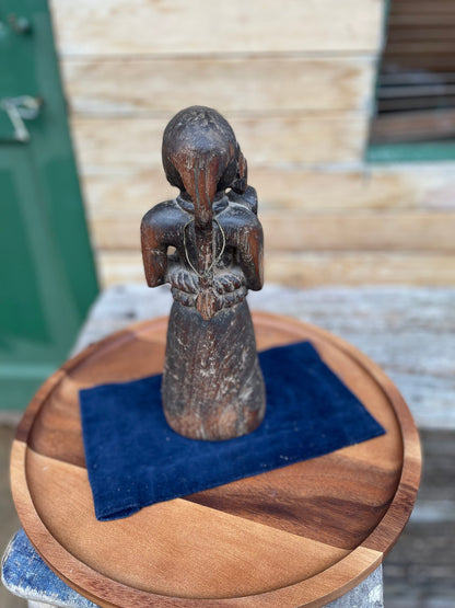 A Hand Carved Folk Art Figure of a mother and child, 29.5cm high