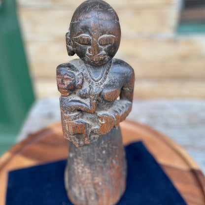 A Hand Carved Folk Art Figure of a mother and child, 29.5cm high