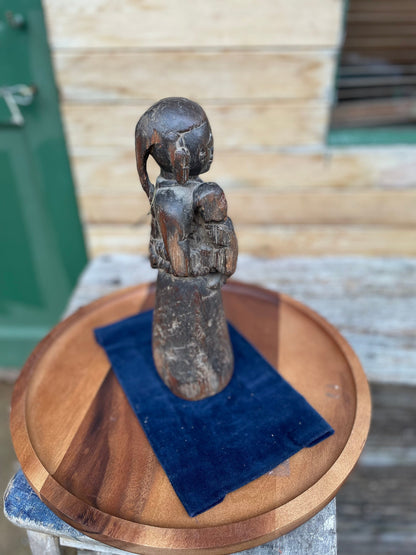 A Hand Carved Folk Art Figure of a mother and child, 29.5cm high