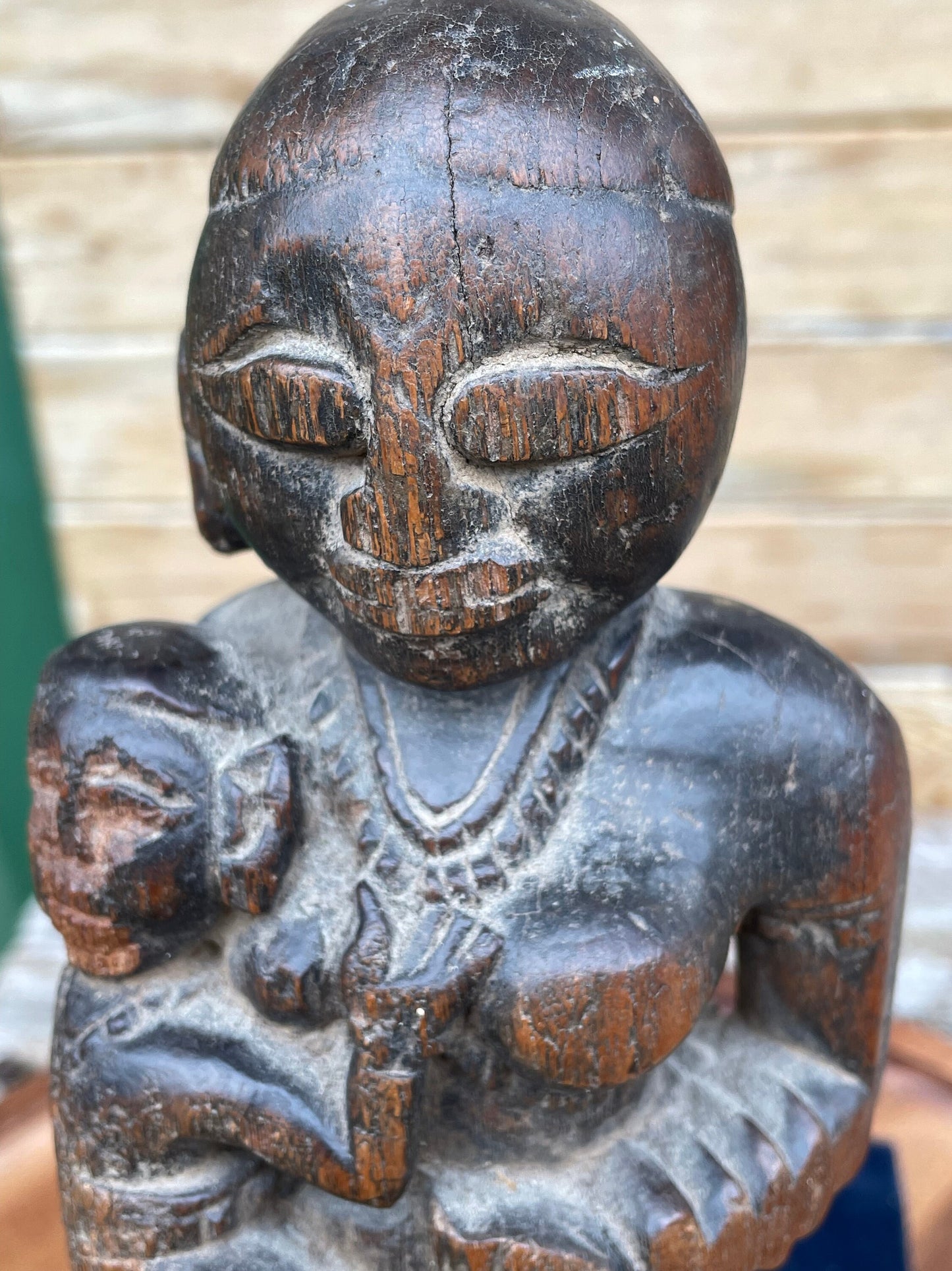 A Hand Carved Folk Art Figure of a mother and child, 29.5cm high