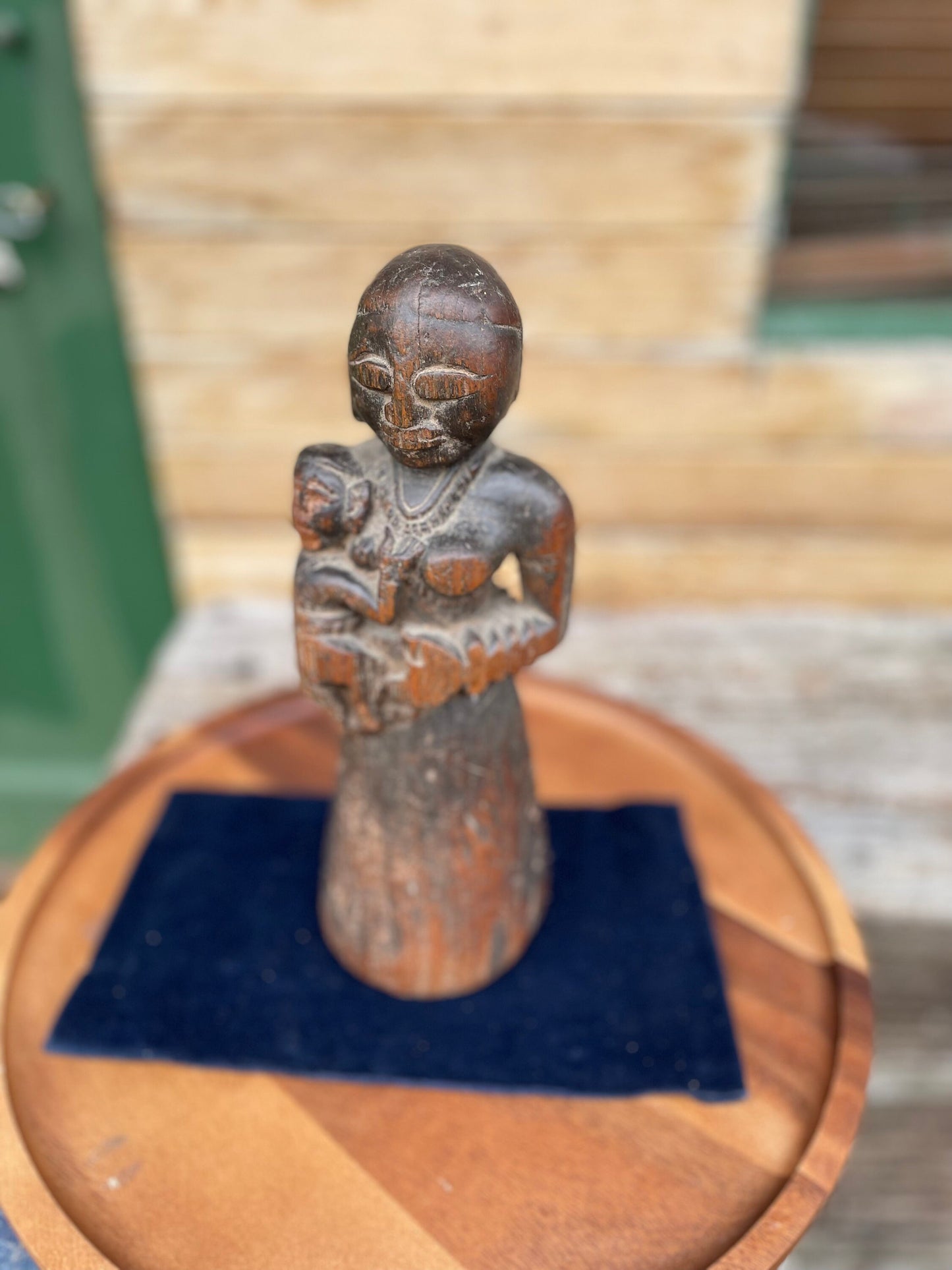 A Hand Carved Folk Art Figure of a mother and child, 29.5cm high