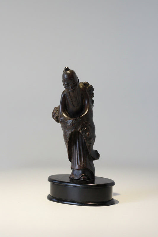 A Chinese Root Wood Hand Carving of an Elder Raised on a Later Oval Ebony Base, Overall 23.5cm High