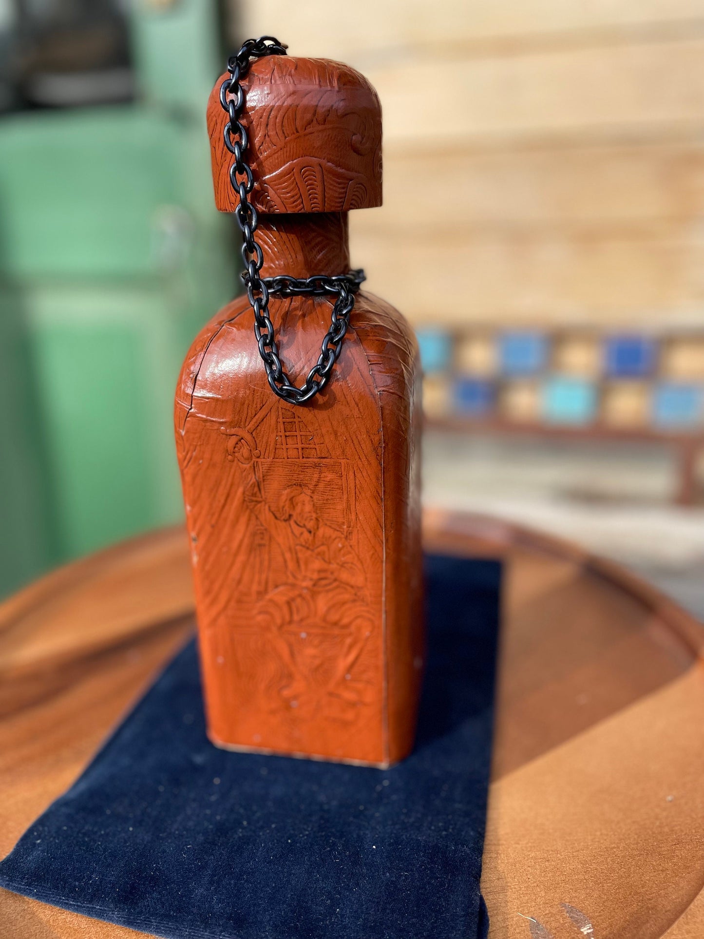 A vintage leather bound decanter with embossed imagery of Don Quixote author Miguel de Cervantes and Spanish text 27cm tall