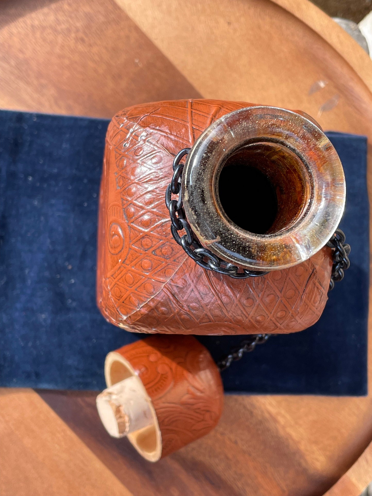 A vintage leather bound decanter with embossed imagery of Don Quixote author Miguel de Cervantes and Spanish text 27cm tall