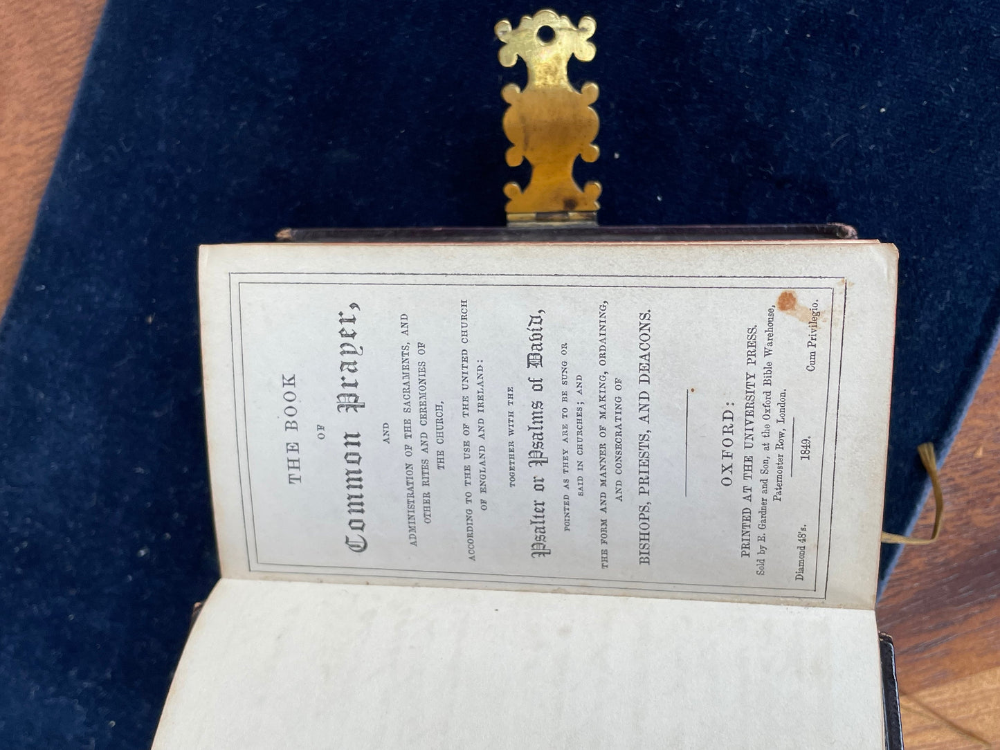 A burgundy leather bound antique Church Services common prayer book with gilt metal fastener 184