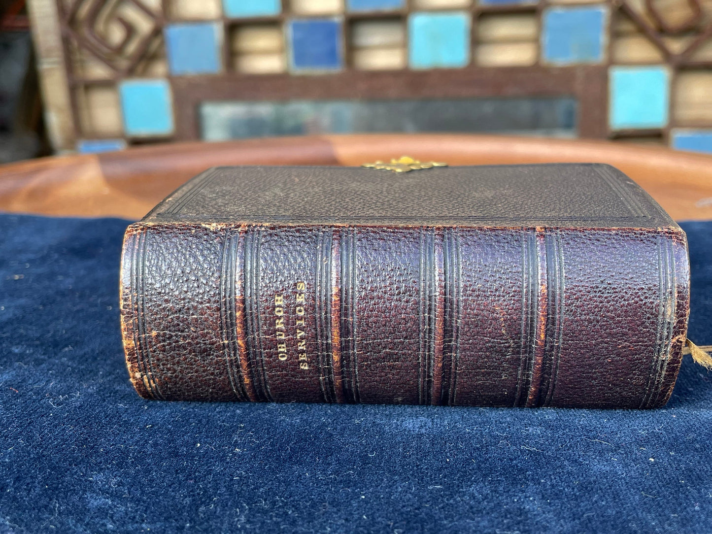 A burgundy leather bound antique Church Services common prayer book with gilt metal fastener 184