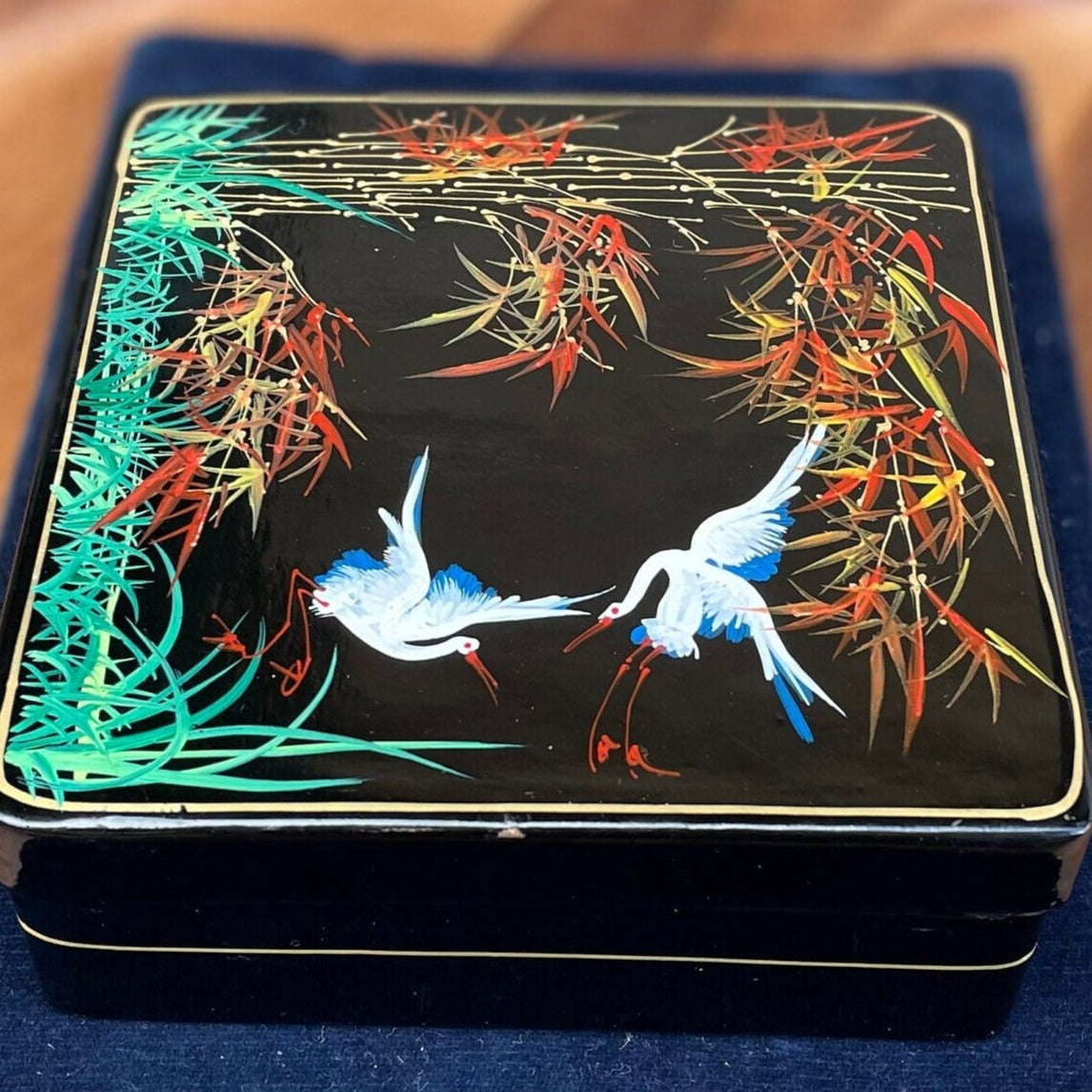 A set of six boxed Japanese lacquer coasters with hand painted egret and bamboo design 12x12cm box 1950's