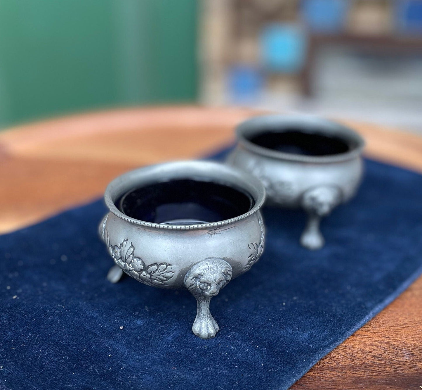 A pair of antique pewter salts with Bristol blue glass liners and lion feet 6.5cm diameter