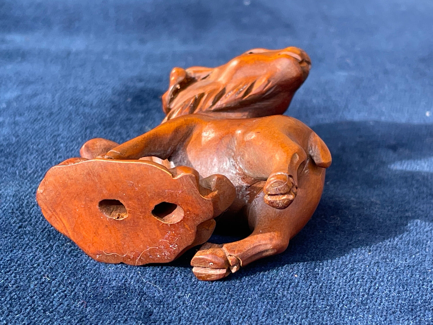 A  Japanese hardwood hand carved Ram netsuke with glass eyes 5cm tall