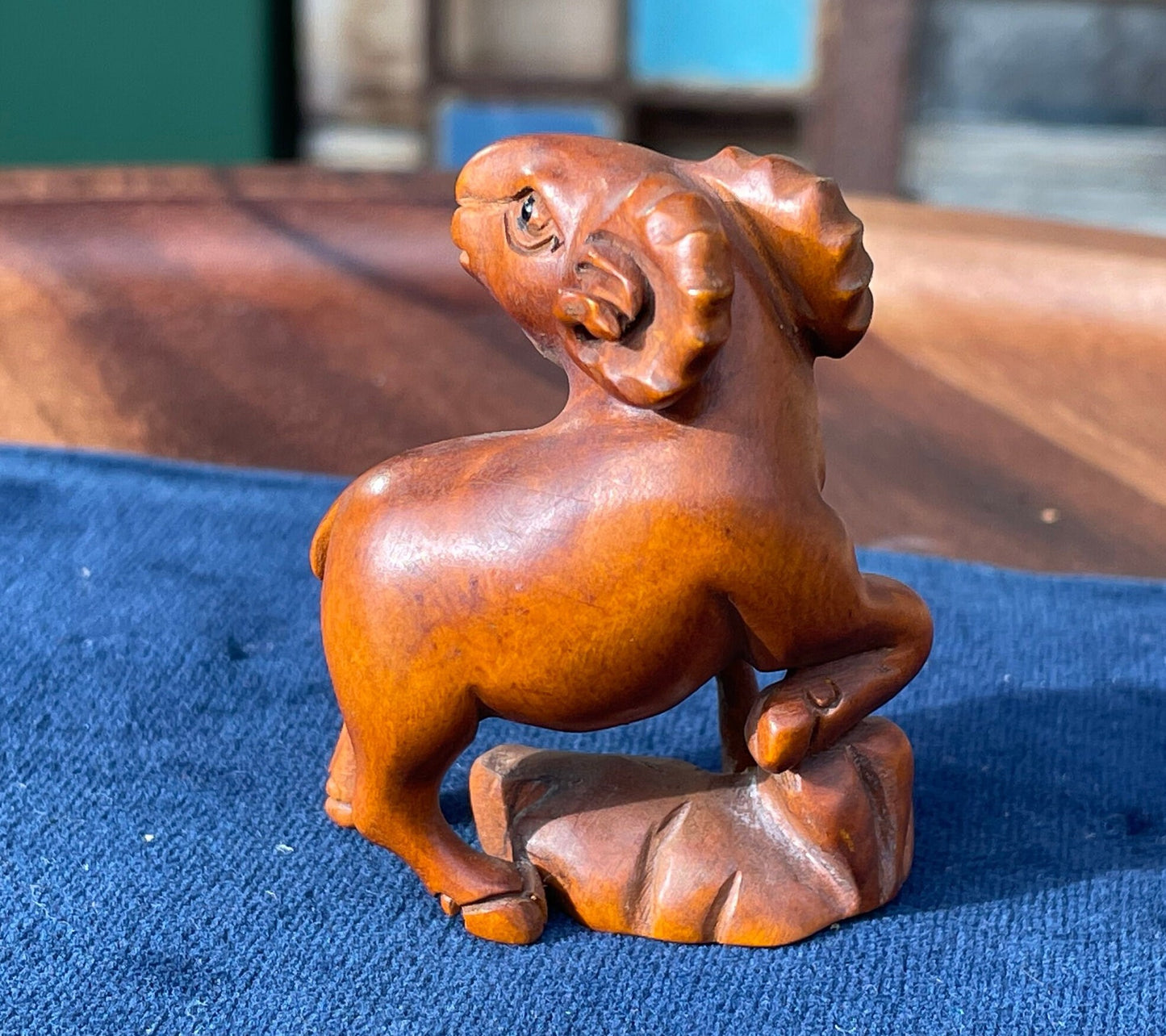 A  Japanese hardwood hand carved Ram netsuke with glass eyes 5cm tall