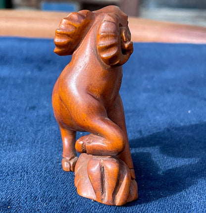 A  Japanese hardwood hand carved Ram netsuke with glass eyes 5cm tall