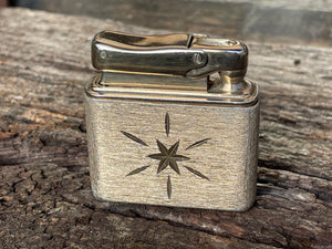 A vintage Colibri fuel lighter engraved with a star and Elizabeth  4.5cm wide