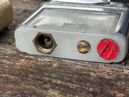 A vintage Colibri fuel lighter engraved with a star motif  4.5cm wide