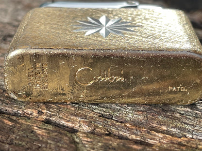 A vintage Colibri fuel lighter engraved with a star motif  4.5cm wide