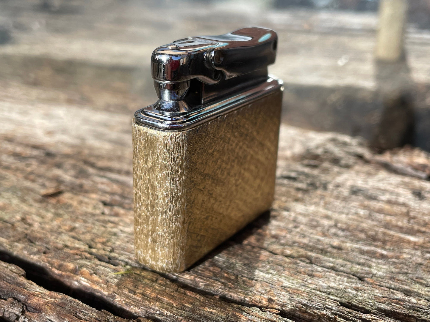 A vintage Colibri fuel lighter engraved with a star motif  4.5cm wide