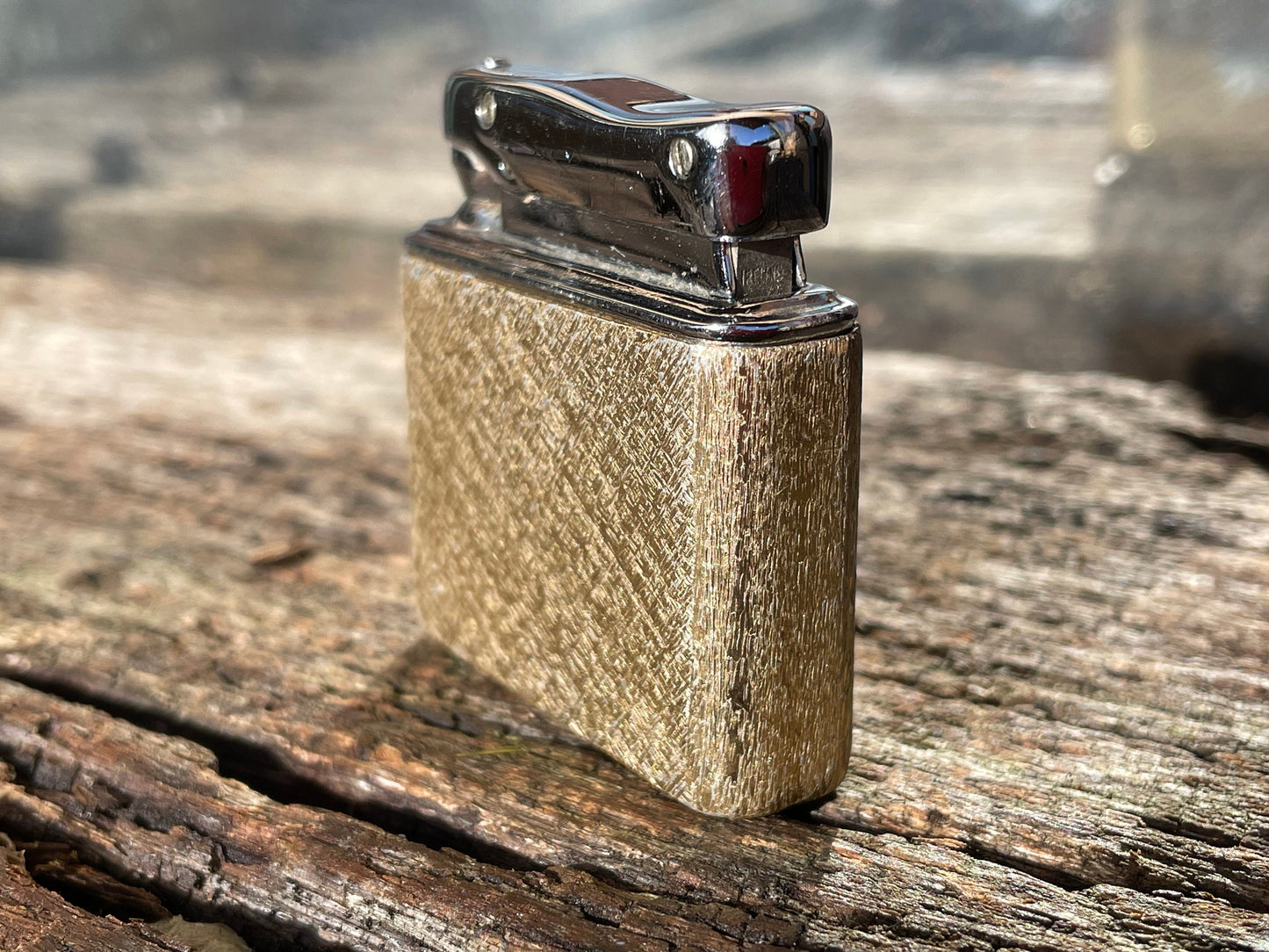 A vintage Colibri fuel lighter engraved with a star motif  4.5cm wide