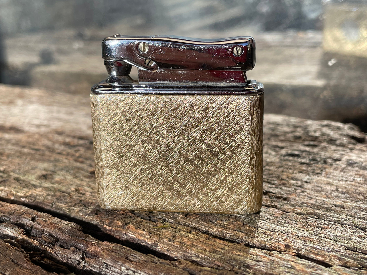 A vintage Colibri fuel lighter engraved with a star motif  4.5cm wide