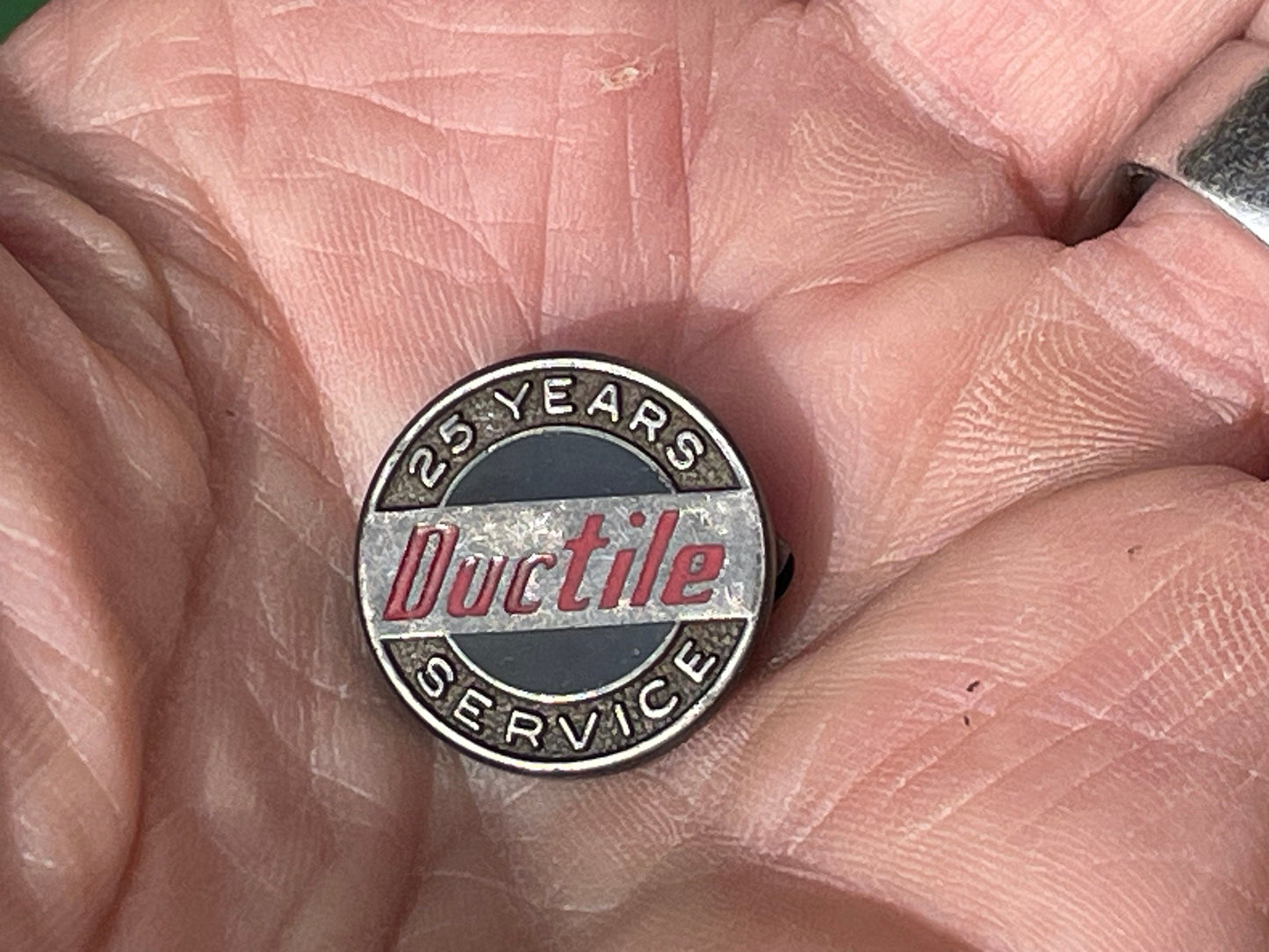 A silver and enamel hallmarked 25 years service at Ductile pin badge - Pendleton & Sons of Birmingham - 1966 2cm dia