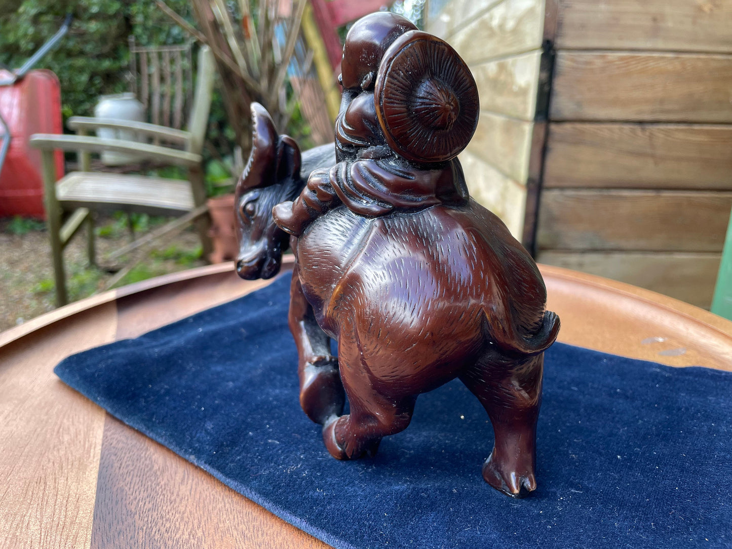 A Chinese ceramic figure of a water buffalo carrying a young monk/boy playing a flute 15cm tall