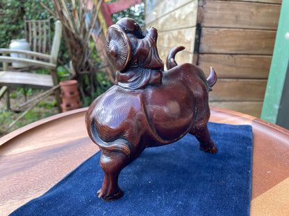 A Chinese ceramic figure of a water buffalo carrying a young monk/boy playing a flute 15cm tall