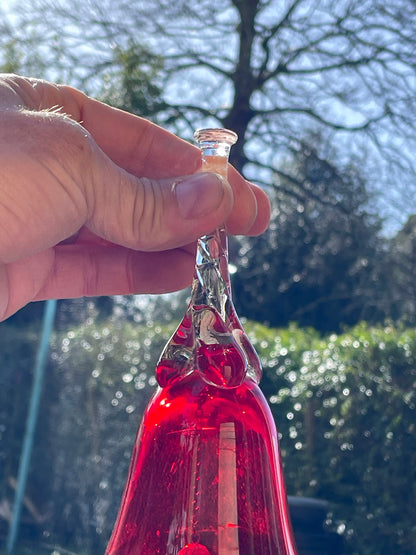 A vintage Ruby red glass hand bell with a twisted stem and crystal clapper 15cm