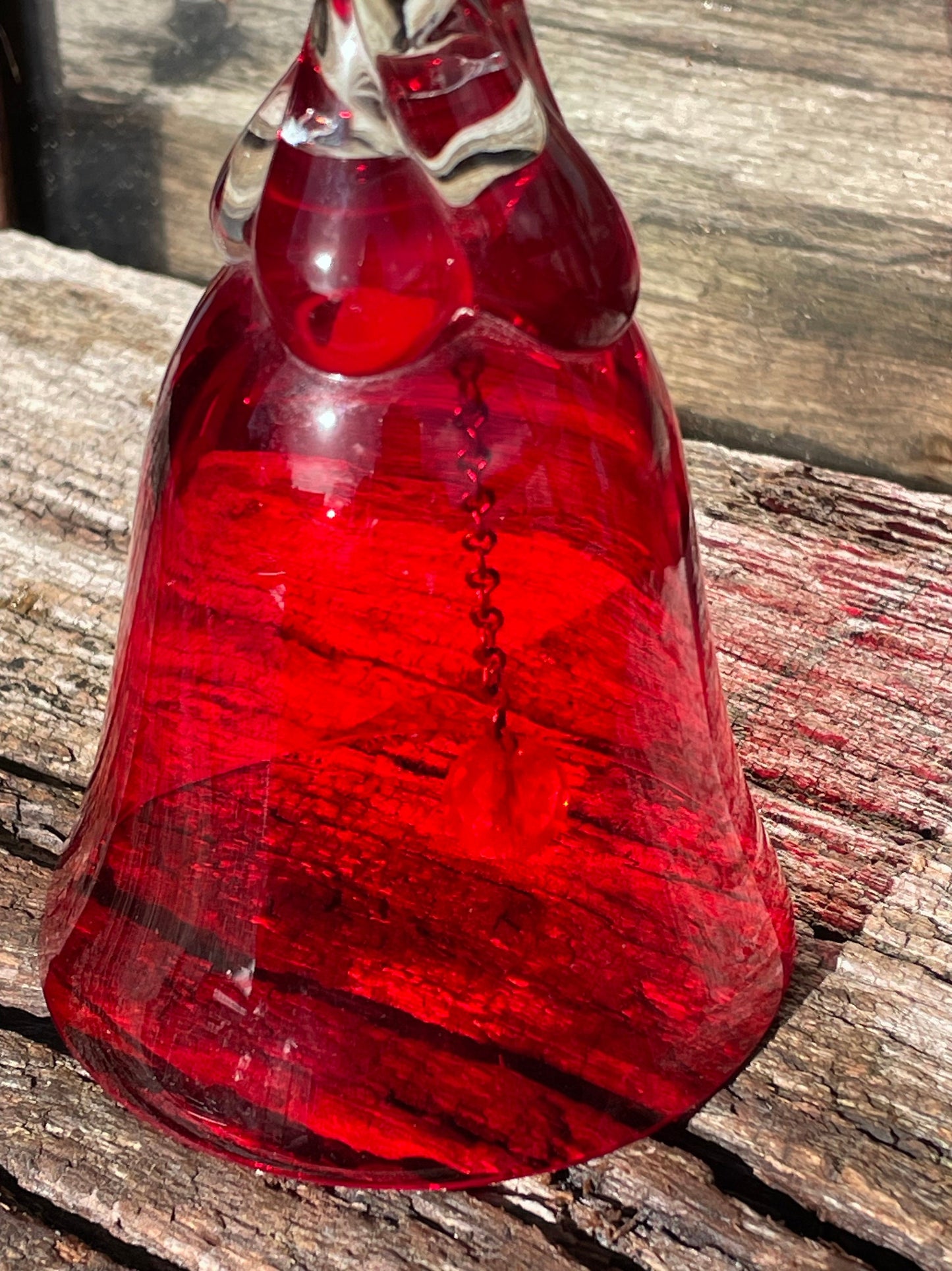 A vintage Ruby red glass hand bell with a twisted stem and crystal clapper 15cm