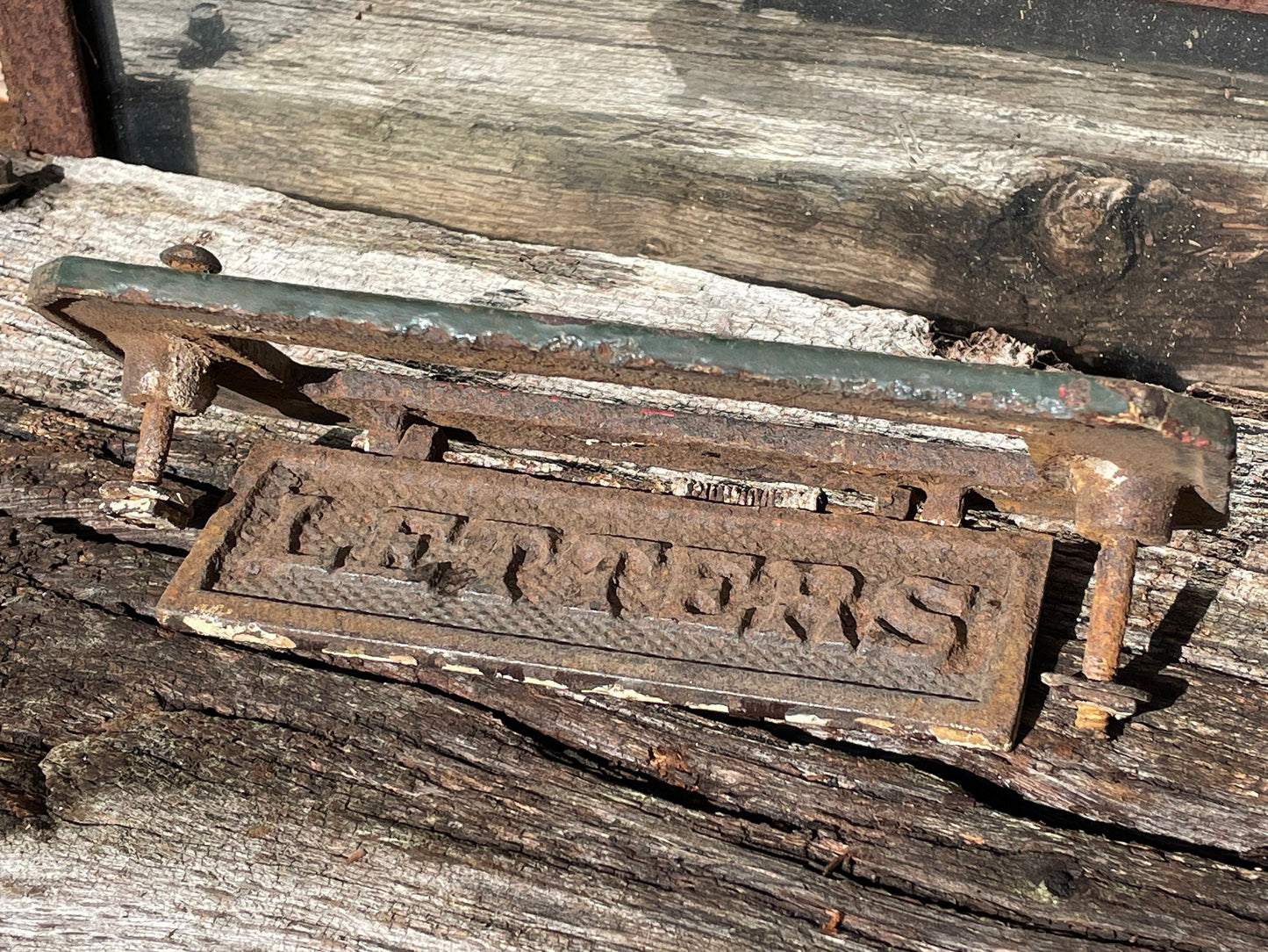 A heavy cast metal antique letter box fascia 19cm wide