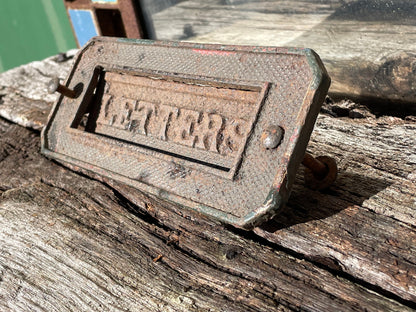 A heavy cast metal antique letter box fascia 19cm wide