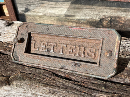 A heavy cast metal antique letter box fascia 19cm wide