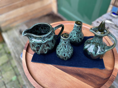 A Cornish  West Country English green honeycomb salt and pepper pot, vinegar pour and Jug set by Fosters Pottery