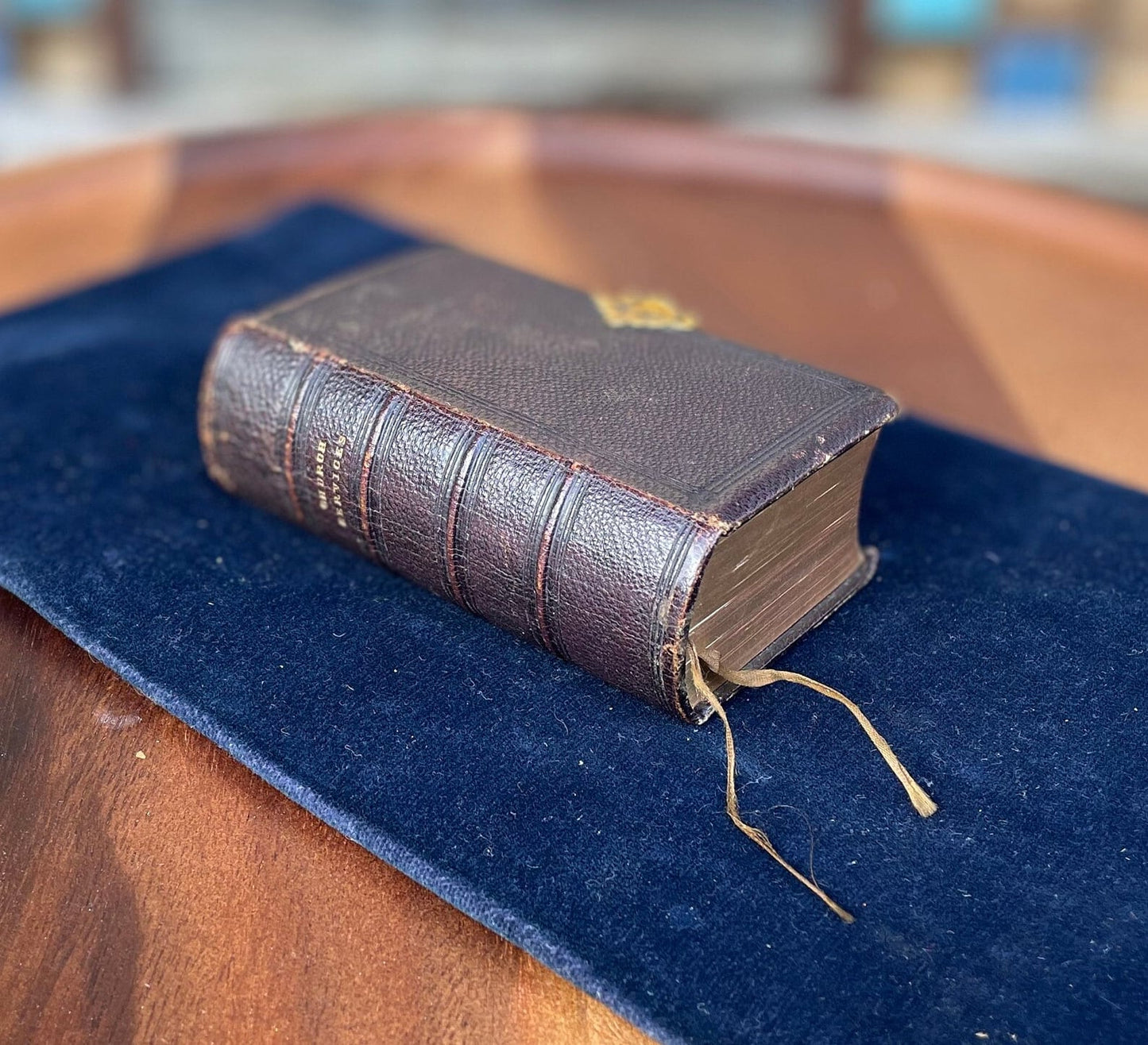 A burgundy leather bound antique Church Services common prayer book with gilt metal fastener 184