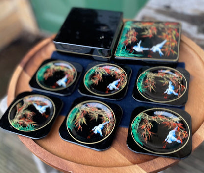 A set of six boxed Japanese lacquer coasters with hand painted egret and bamboo design 12x12cm box 1950's