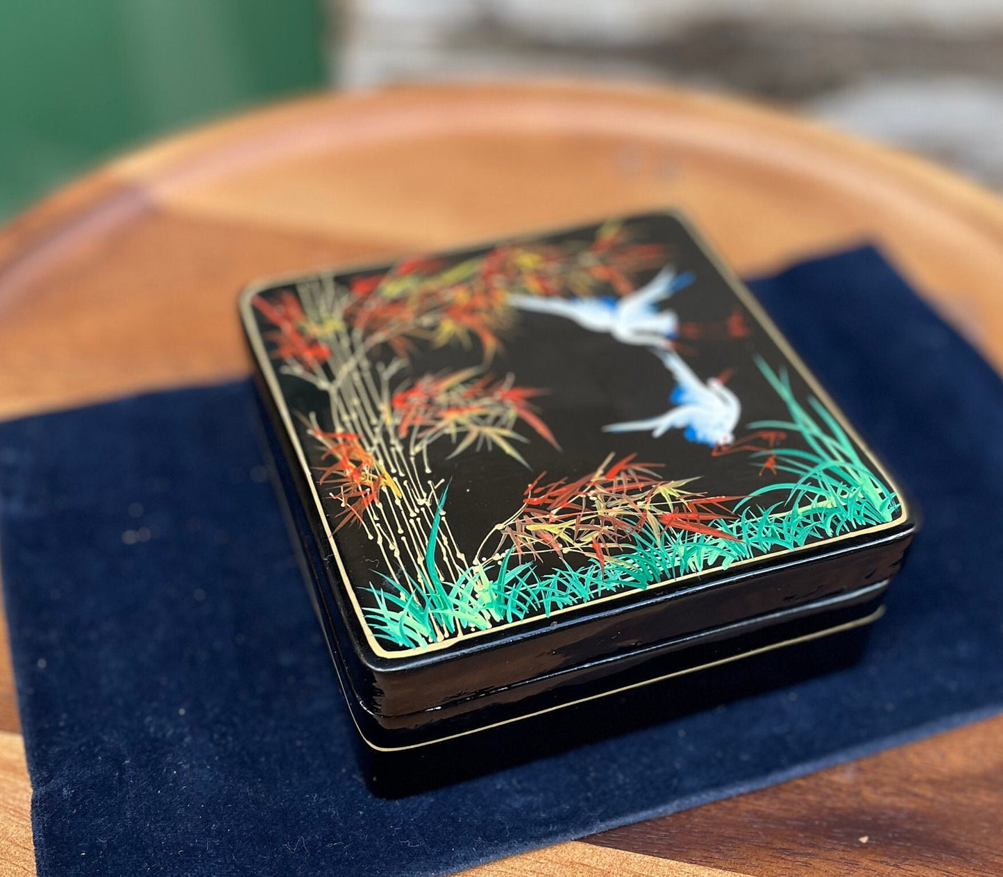 A set of six boxed Japanese lacquer coasters with hand painted egret and bamboo design 12x12cm box 1950's