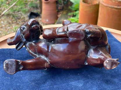 A Chinese ceramic figure of a water buffalo carrying a young monk/boy playing a flute 15cm tall