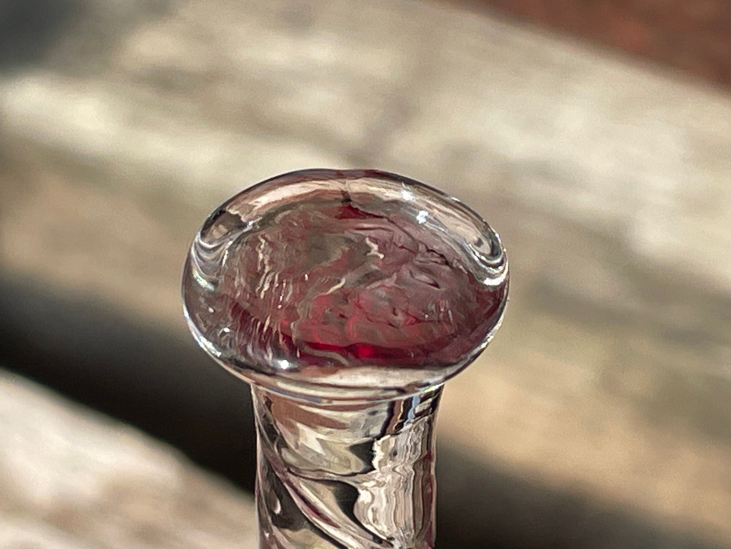 A vintage Ruby red glass hand bell with a twisted stem and crystal clapper 15cm