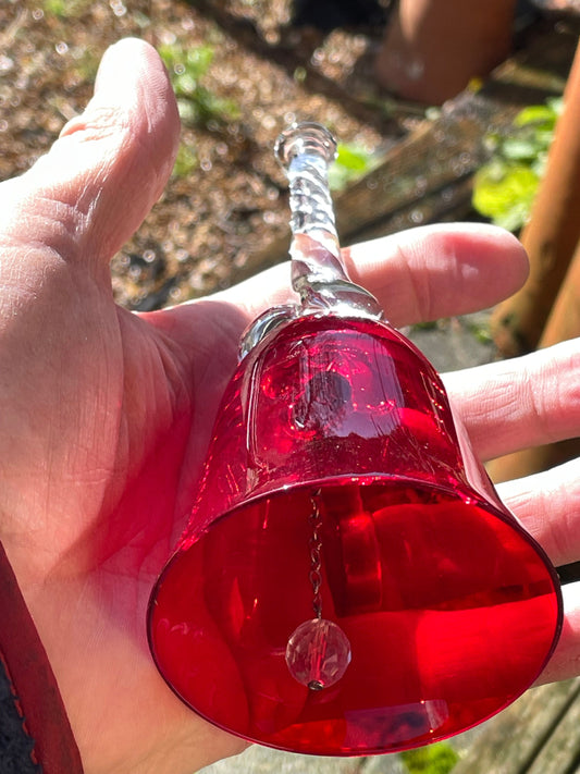 A vintage Ruby red glass hand bell with a twisted stem and crystal clapper 15cm