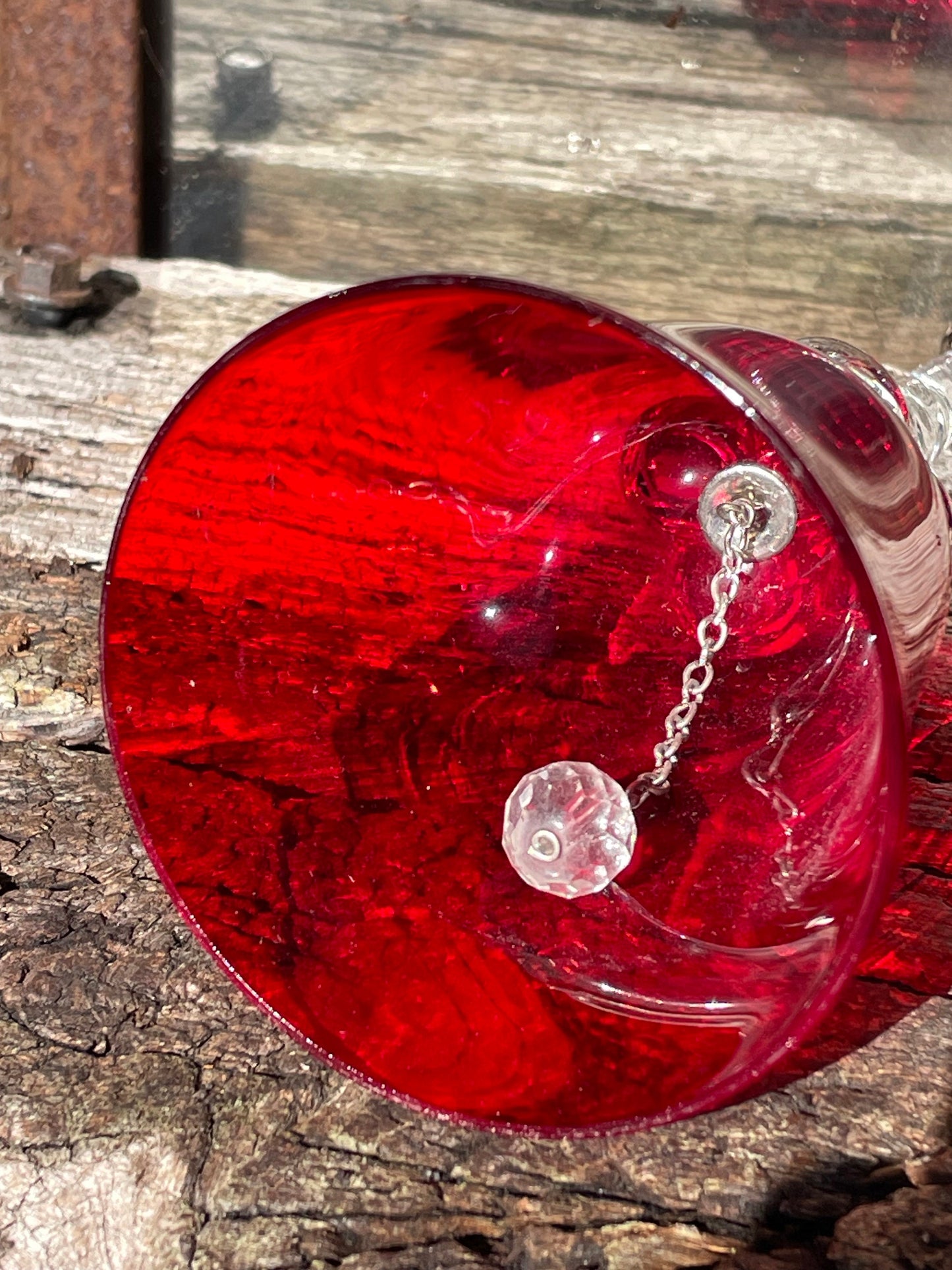 A vintage Ruby red glass hand bell with a twisted stem and crystal clapper 15cm