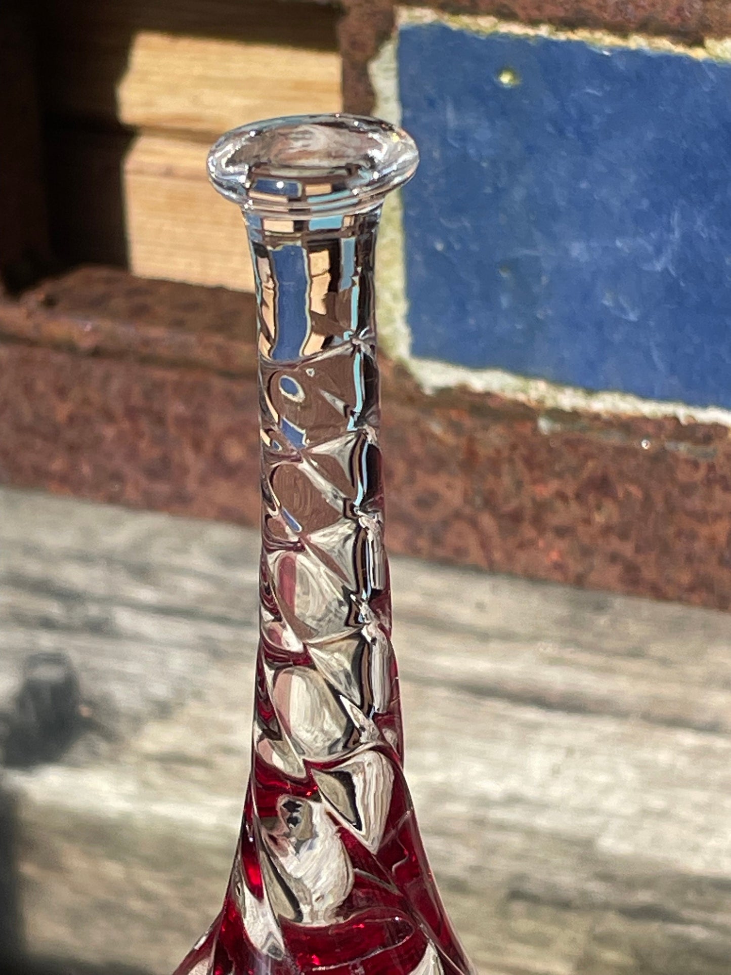 A vintage Ruby red glass hand bell with a twisted stem and crystal clapper 15cm