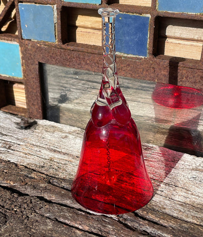 A vintage Ruby red glass hand bell with a twisted stem and crystal clapper 15cm