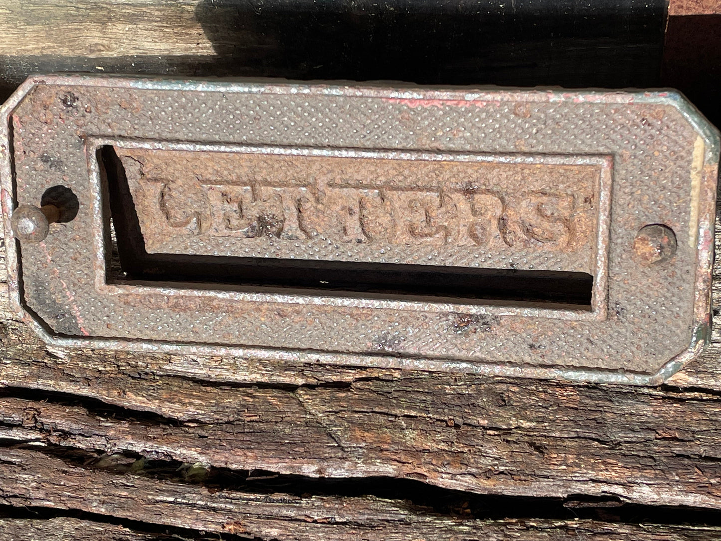 A heavy cast metal antique letter box fascia 19cm wide