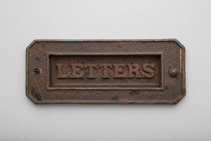 A heavy cast metal antique letter box fascia 19cm wide