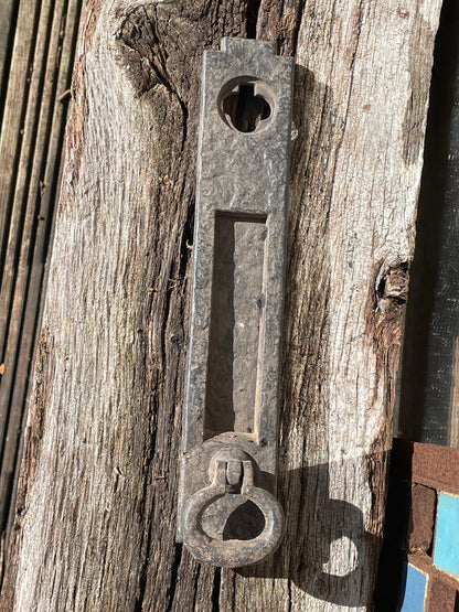 A heavy cast metal antique letter box and knocker combined fascia 31cm tall